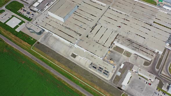 Industrial complex. Roofs of manufacture buildings on green field. alt