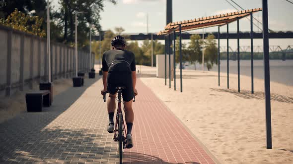 Triathlete Cyclist Training On Bicycle. Fit Athlete Workout Training Cycling Triathlon Competition. alt