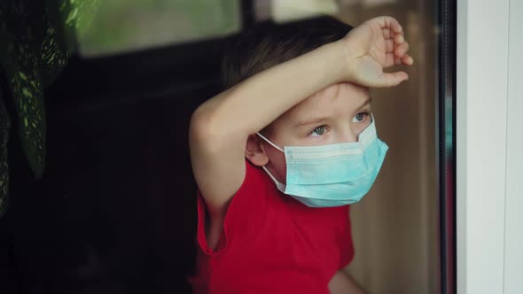 a Masked Boy Looks Out the Window alt