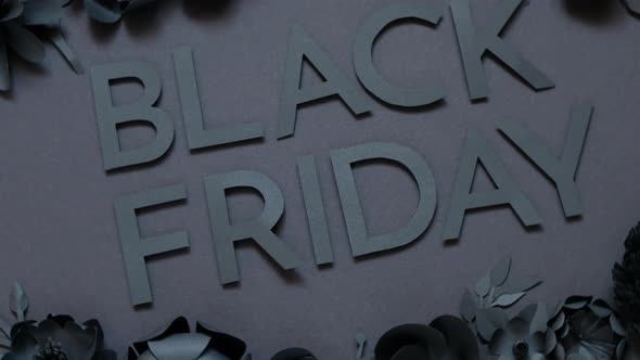 Black friday offer. Black paper flowers on Black background. Cut from paper. alt