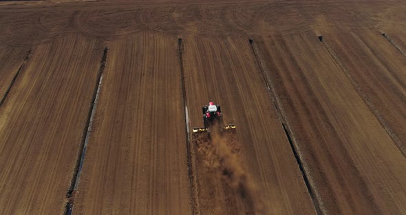 Peat Harvesting Plowing Tractor Extracting Turf in Drained Bog Aerial View alt