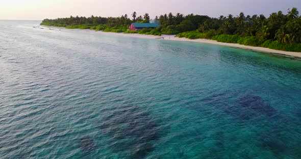 Wide flying abstract shot of a sandy white paradise beach and aqua turquoise water background in bes alt