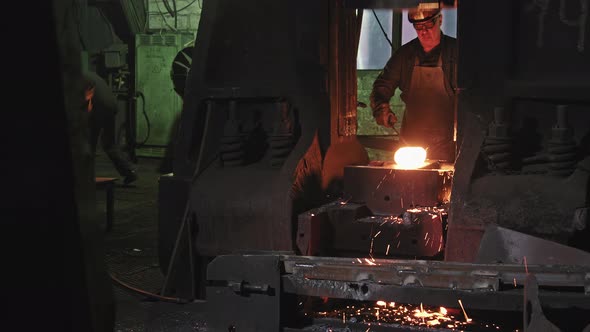 Forger Man Working With Hot Steel At Forgery Shop alt