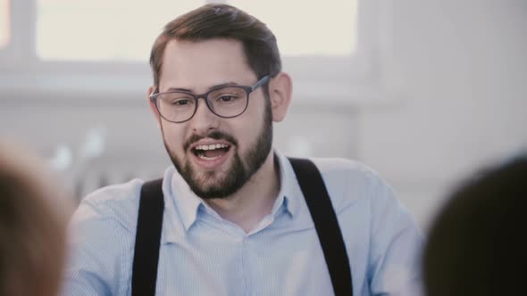 Close-up Portrait of Young Successful Handsome Businessman Smiling, Talking at Modern Healthy alt