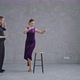 Man Teaching Woman Dancing Tango in Grey Studio Against Large Windows - VideoHive Item for Sale