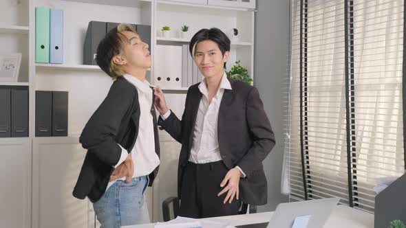 Portrait of Asian handsome businessman gay people working in office then looking at camera. alt