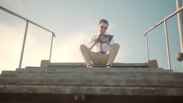Businessman Relaxing And Enjoying Near River Resting Holding Book. Businessman Take Break Relax. alt