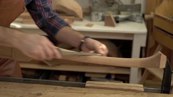 Carpenter Polishes Cabrioli Leg in his Workshop alt