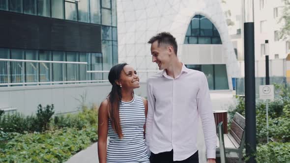 Happy Multiracial Couple Having Date in Modern City Center One Summer Day alt
