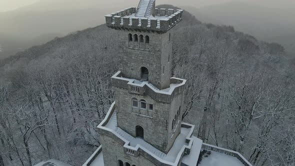 Observation Tower on Mount Akhun Covered in Winter During Snowfall alt