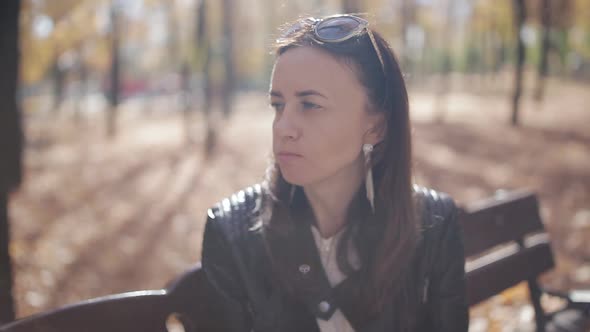 Business Girl on a Park Bench Eating a Croissant and Drinking Coffee From a Paper Cup Clouse Up alt