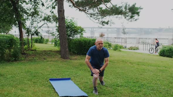 Sporty Grandpa or Grandfather in Sportwear Training Outdoor in City Park