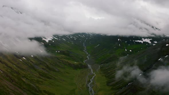 Aerial View of Nordic Landscape Flyover Green Valley Beautiful Formations and Mountains Covered with alt