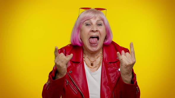 Overjoyed Delighted Crazy Elderly Woman Showing Rock n Roll Gesture By Hands Cool Sign Dancing alt