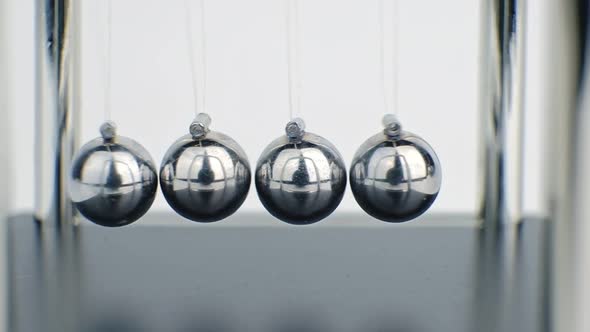 Slow motion shot of Newton's metal balls on white background.Macro shot