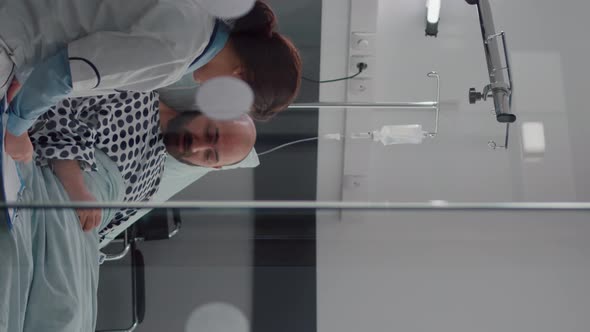 Vertical Video Medical Asssistant Checking Patient Vitals Monitoring Heart Rate Injecting Vitamin alt