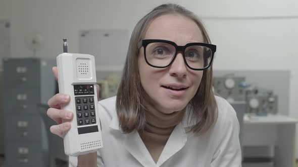 Vintage style scientist holding a brand new cordless phone