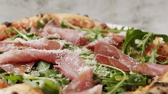Delicious Pizza with Prosciutto Parma Ham Arugula Salad Rocket with Ingredients alt