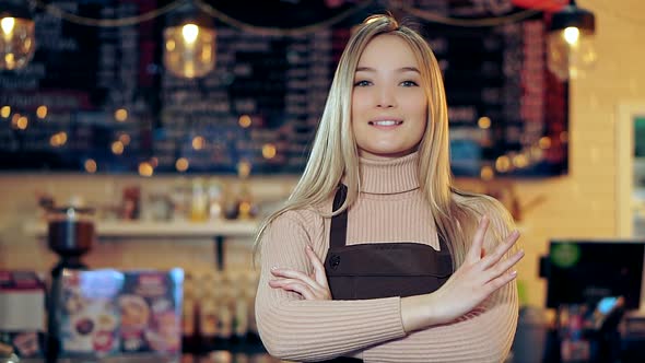 Portrait of an Attractive Girl Waiter in a Coffee Shop alt