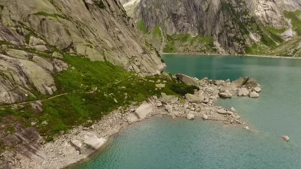 mountain lake in the swiss alps, reservoir in the middle of the mountains alt