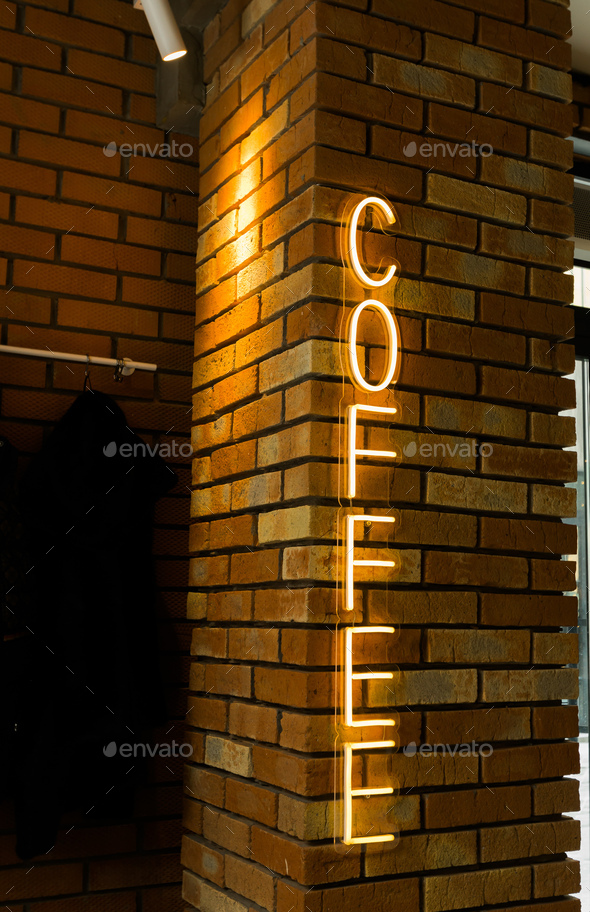Coffee neon sign emblem in neon style on brick wall background. Coffee shop