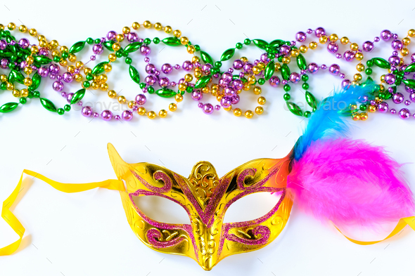 Carnival mask with feathers and colorful beads on white background. Mardi Gras or Fat Tuesday symbol