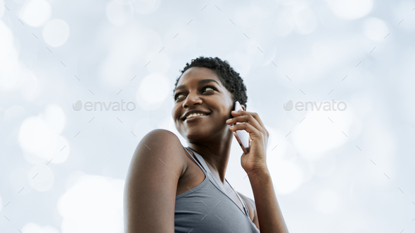 Black woman talking on the phone - Stock Photo - Images