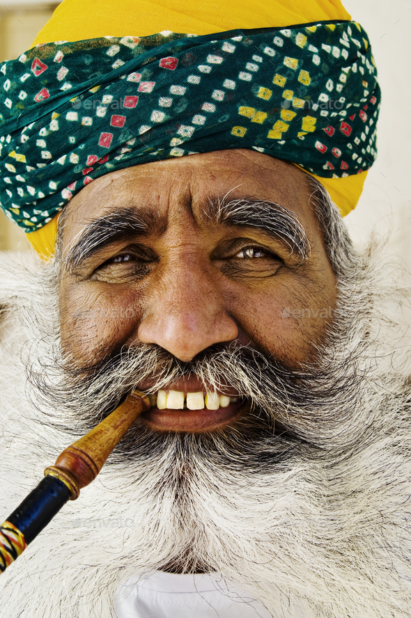 India man smoking a pipe - Stock Photo - Images