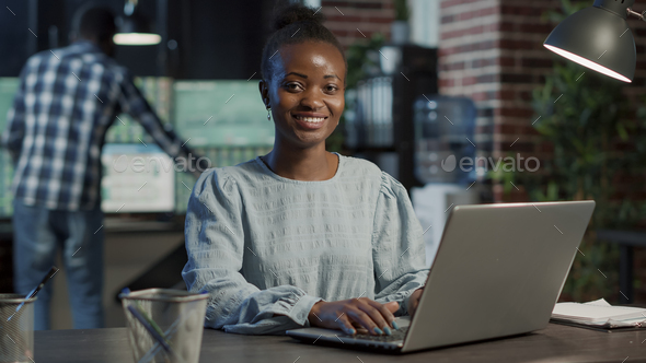 Portrait of sales assistant working on laptop to create capital profit - Stock Photo - Images