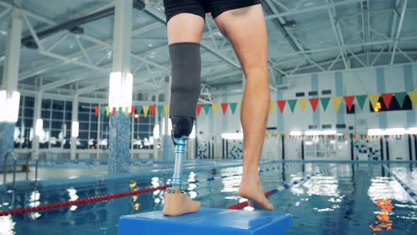 Disabled Man Training at a Pool, Bionic Leg Prosthesis alt