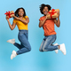 Happy young black couple with presents jumping up - PhotoDune Item for Sale