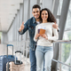 Travel Advertisement. Happy Young Arab Couple Posing At Airport - PhotoDune Item for Sale