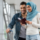 Young Islamic Spouses Waiting For Flight Boarding At Airport Terminal - PhotoDune Item for Sale