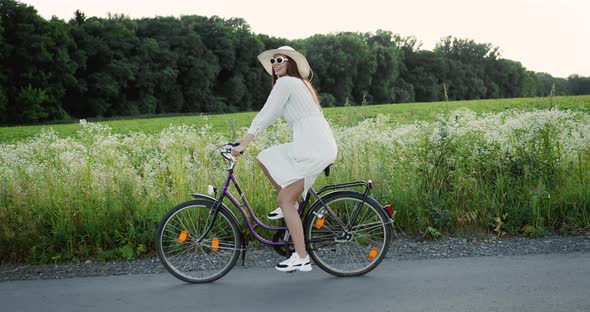 Woman Riding Bicycle in Countryside