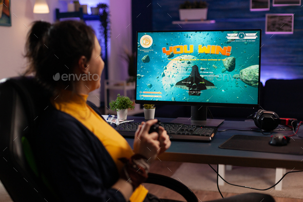 Person playing video games with controller on computer Stock Photo