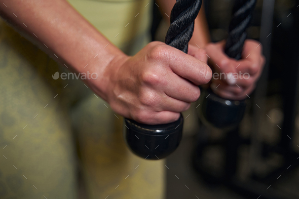 Focused photo on female hands holding rope Stock Photo by svitlanah