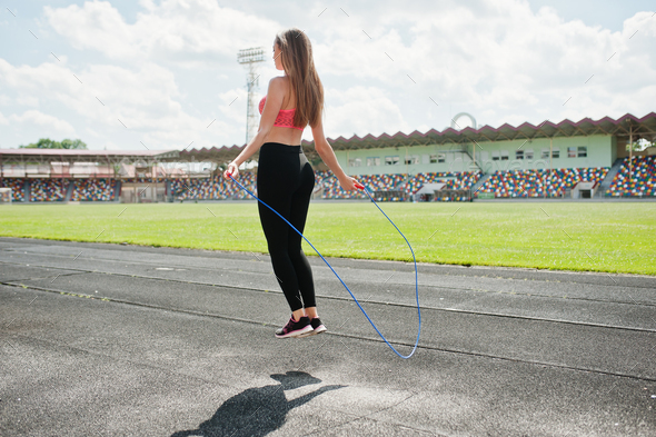 Fitness sporty girl in sportswear at stadium outdoor sports. Happy