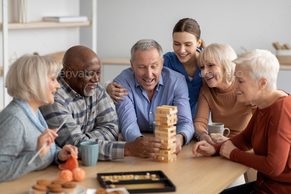 Cheerful multiracial senior people playing jenga at sanatorium Stock ...