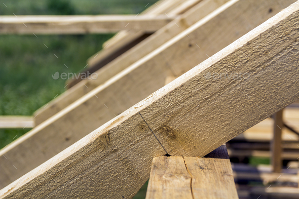 New wooden ecological house from natural materials under construction. Close-up detail of attic roof