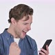 Young Man Celebrating on Smartphone, Success on White Background - VideoHive Item for Sale