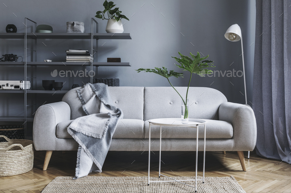Stylish nordic living room with design grey sofa.