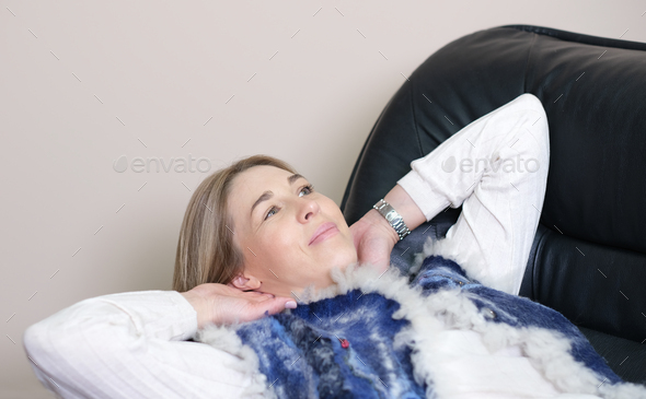 woman getting rest on a couch relaxing after difficult working day. having a break