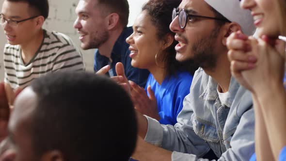 Fans cheering for sport team at home