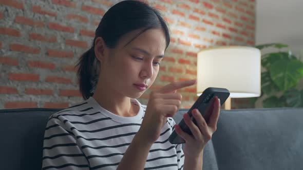 woman using smartphone and showing signs of joy with celebrating success.