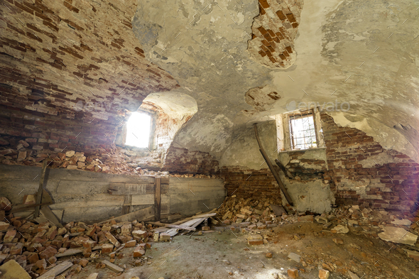 Old forsaken empty basement room of ancient building or palace with cracked plastered brick walls - Stock Photo - Images