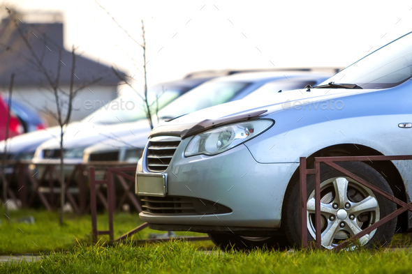Cars parked on a parking lot in city - Stock Photo - Images