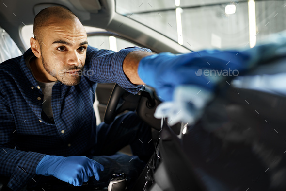 A man cleaning car interior, car detailing in Carwash service Stock Photo