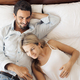 Happy Attractive Smiling Couple Lying On Bed In Bedroom - PhotoDune Item for Sale