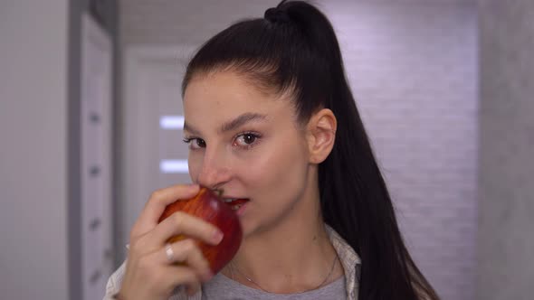 Smiling Happy Woman Biting Big Red Apple