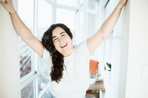 Young woman with long hair portrait smiling and having fun on a modern city flat. Life at the city